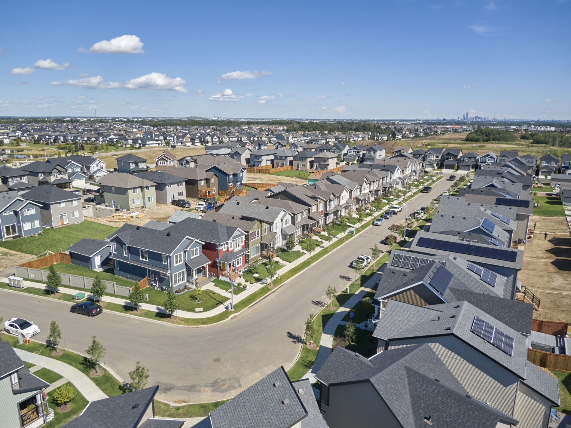 Aerial photo of a street in a community that is lined with new homes