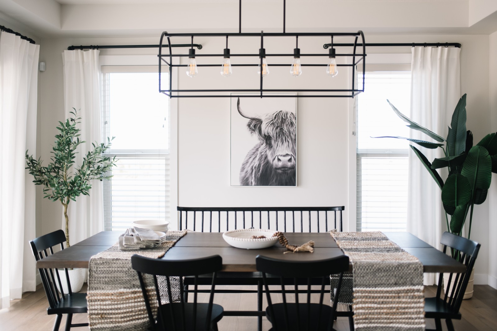 Natural light floods the dining room of the Odessa showhome through two windows behind the dining table