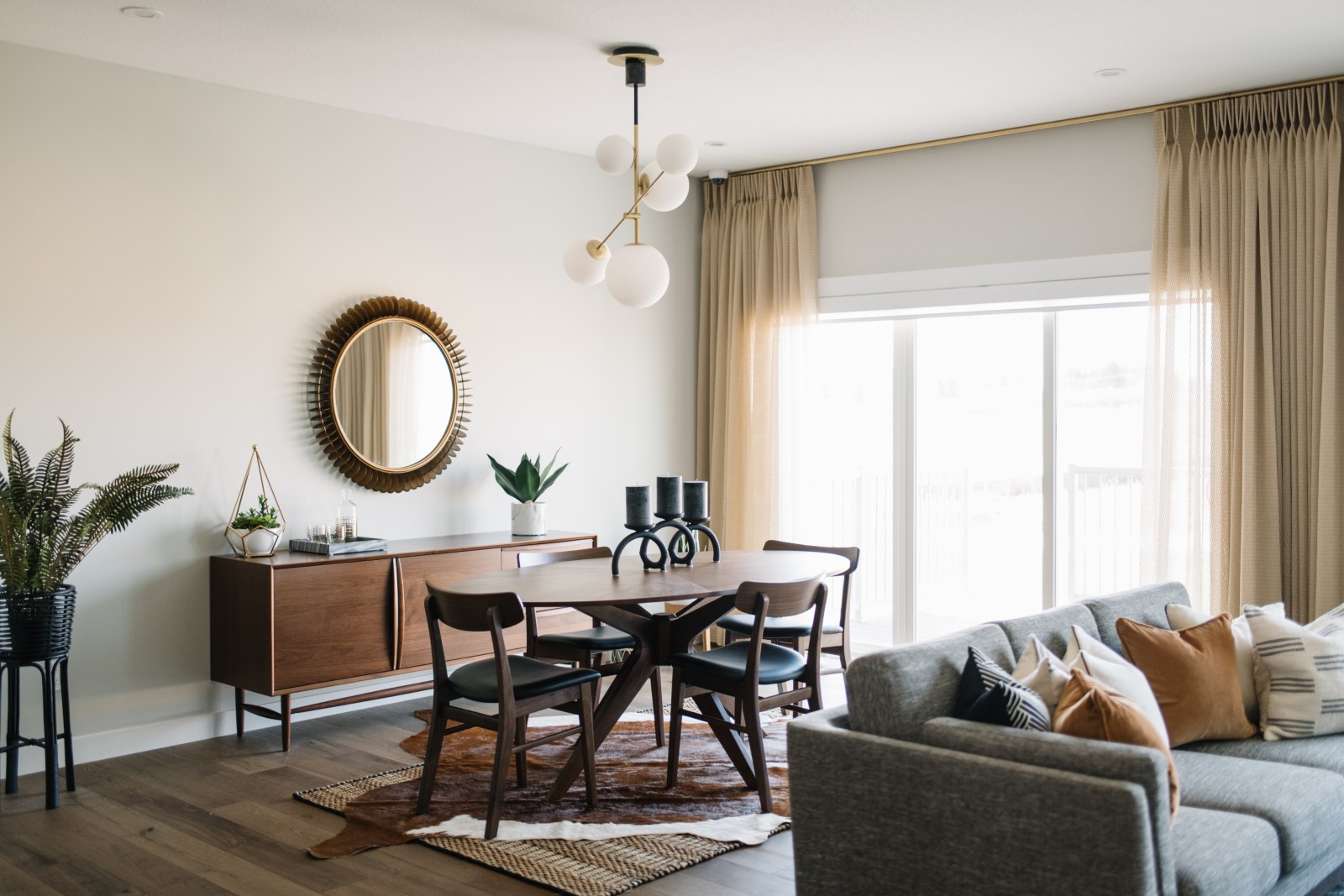 Bianca showhome dining nook featuring ceiling to floor curtains with mid century table and side board