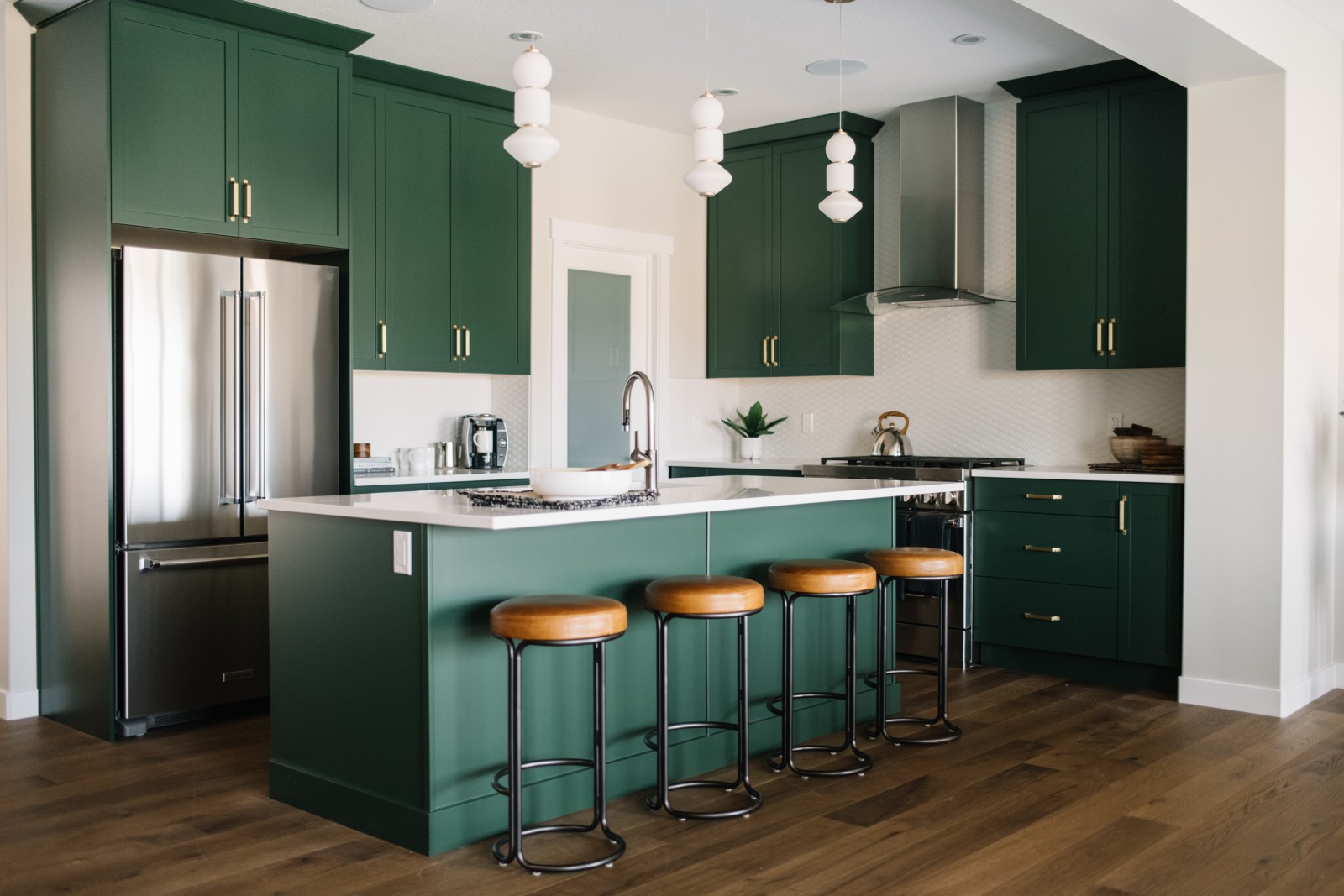 An overall picture of the green kitchen cabinets in the Bianca showhome
