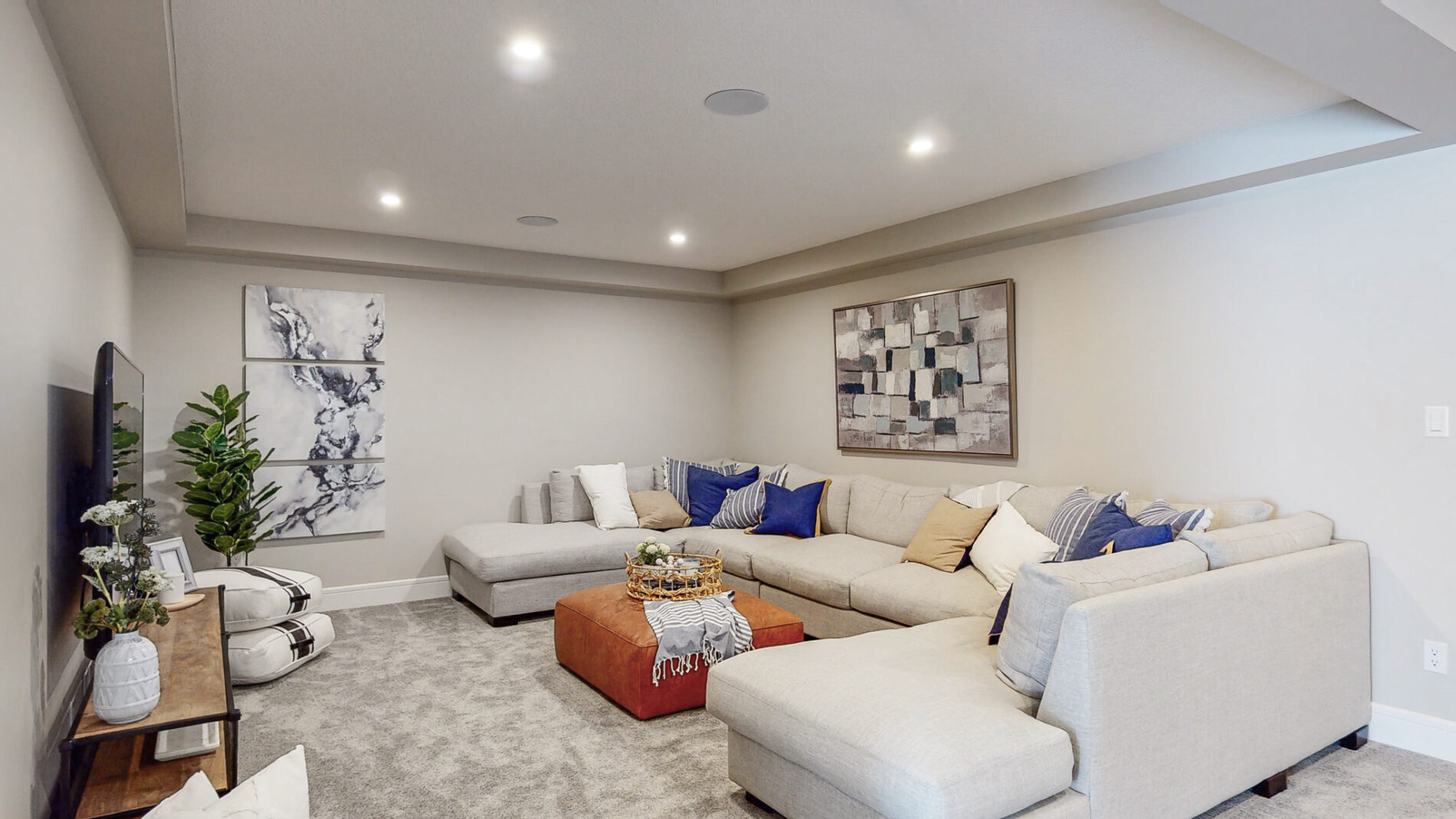 The large bonus room of the Kalliope showhome in Ardrossan with tray ceiling detail, and space for an oversized sectional and ottoman