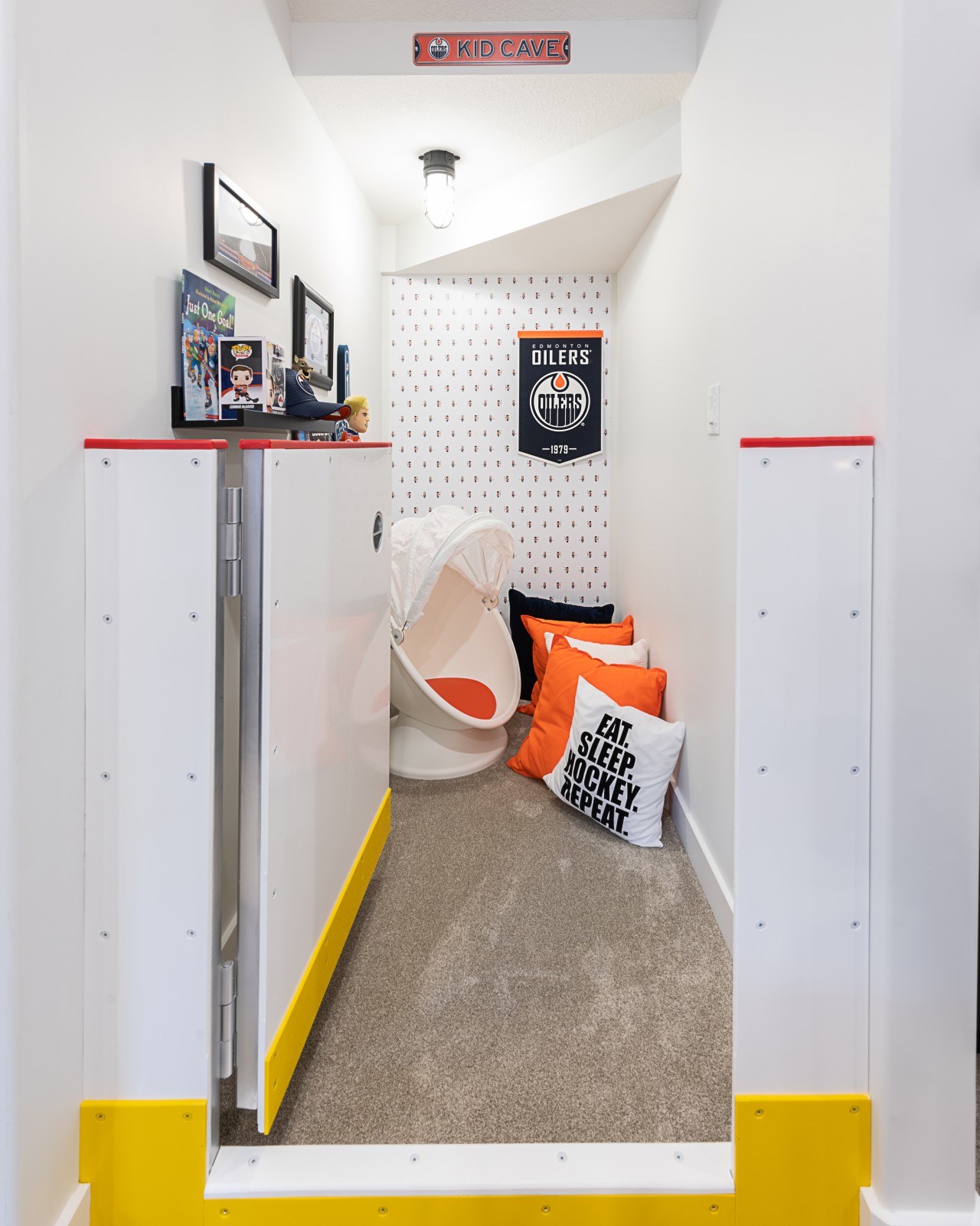 Fun kids penalty box, reading nook in Oilers Fan cave in basement of Dione showhome