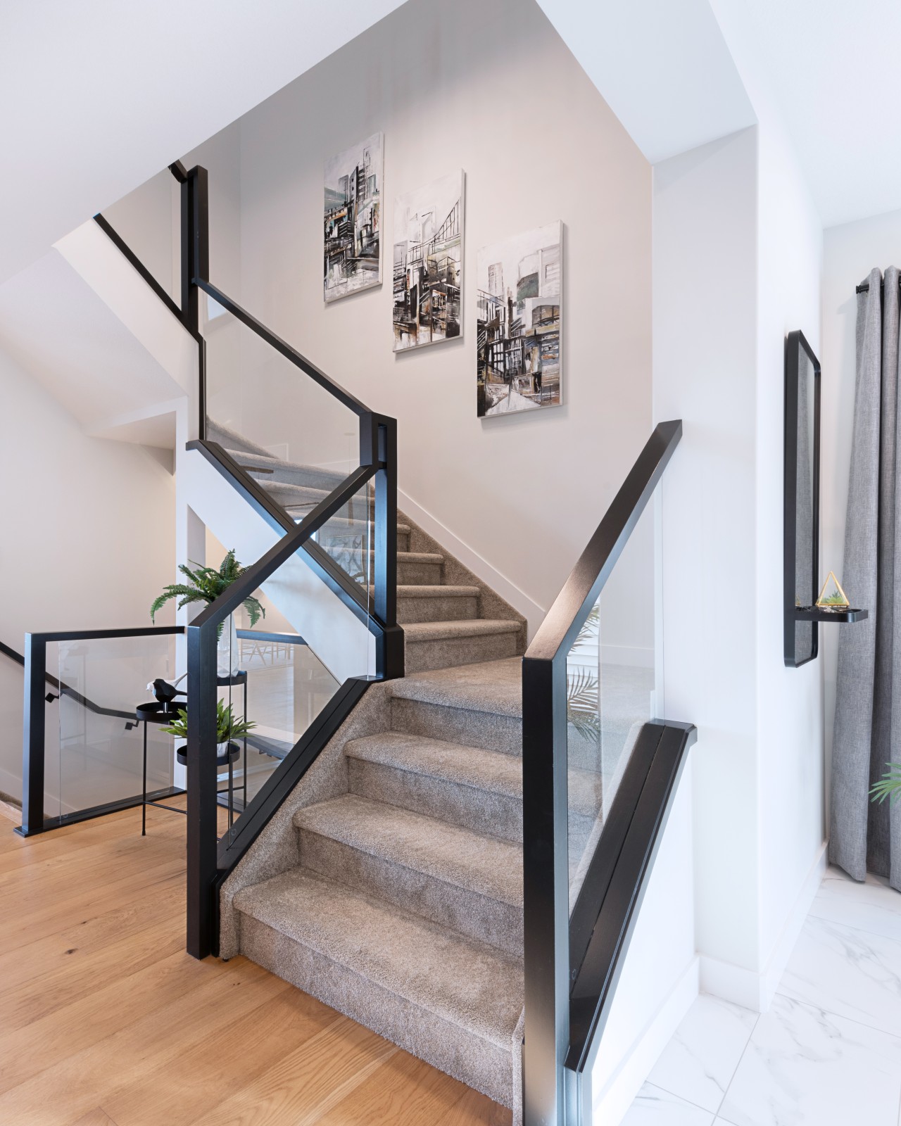Glass and black painted railing leading to the second floor of the Dione showhome