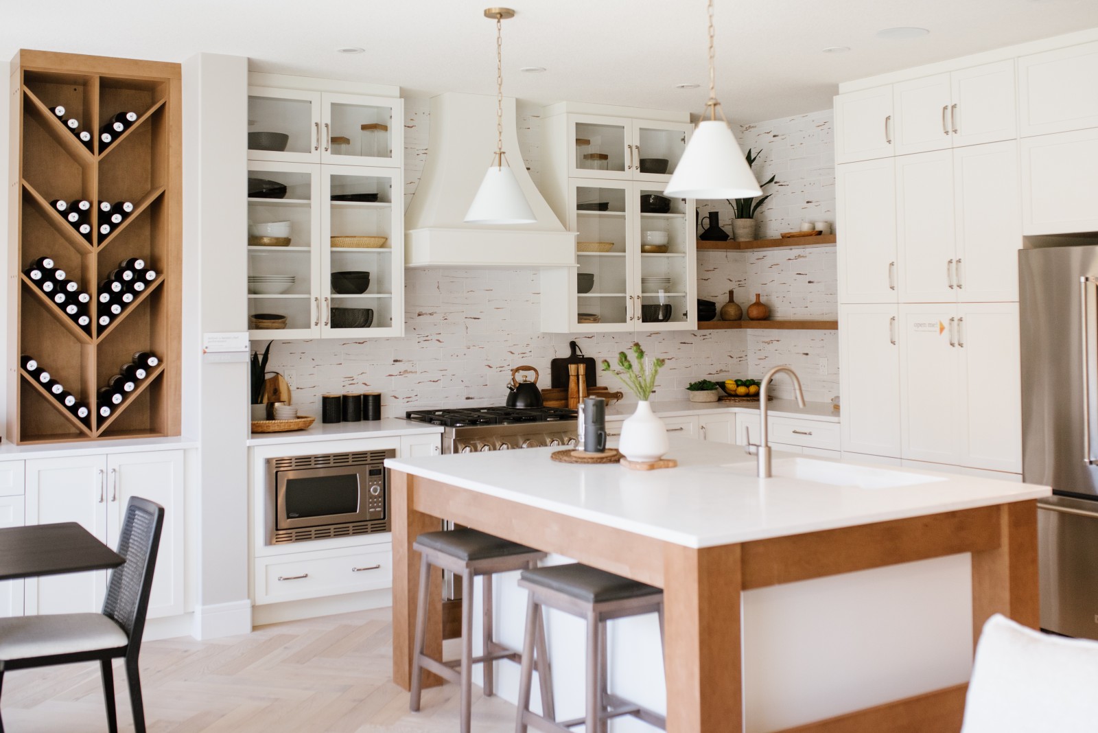 A warm, inviting two-toned white and wood kitchen with custom wood trimmed island with flush eating bar
