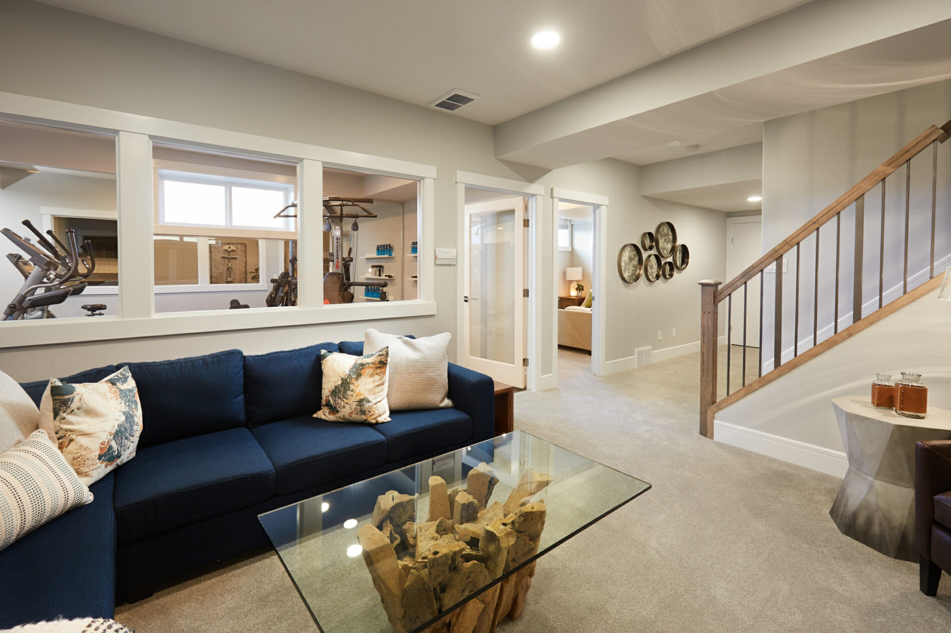 Basement with wall of windows looking in to the home gym