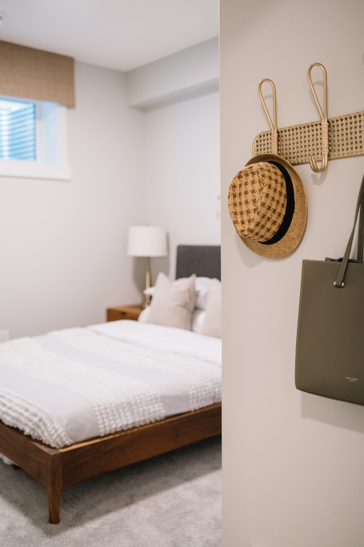 Basement bedroom with hooks for a hat and bag as you enter the room
